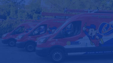 3 red, white and blue electrician service vans parked beside one another