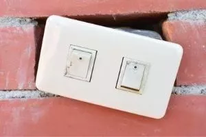 light switch out on a brick wall